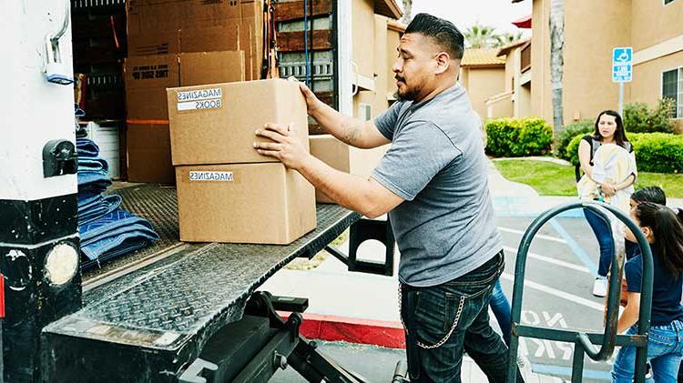 Man packing moving truck to relocate for a job.